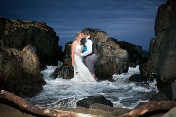 bride and groom kissing in the dramatic light